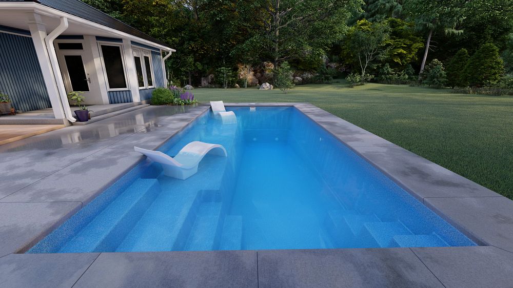 A modern swimming pool with clear blue water, surrounded by a concrete deck. Two white lounge chairs are positioned partly in the water. A house with a blue exterior and green landscaping is visible in the background.